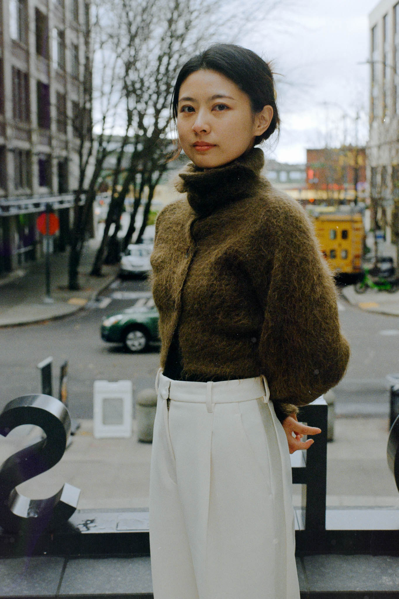 Color image of a woman standing looking straight at the camera
