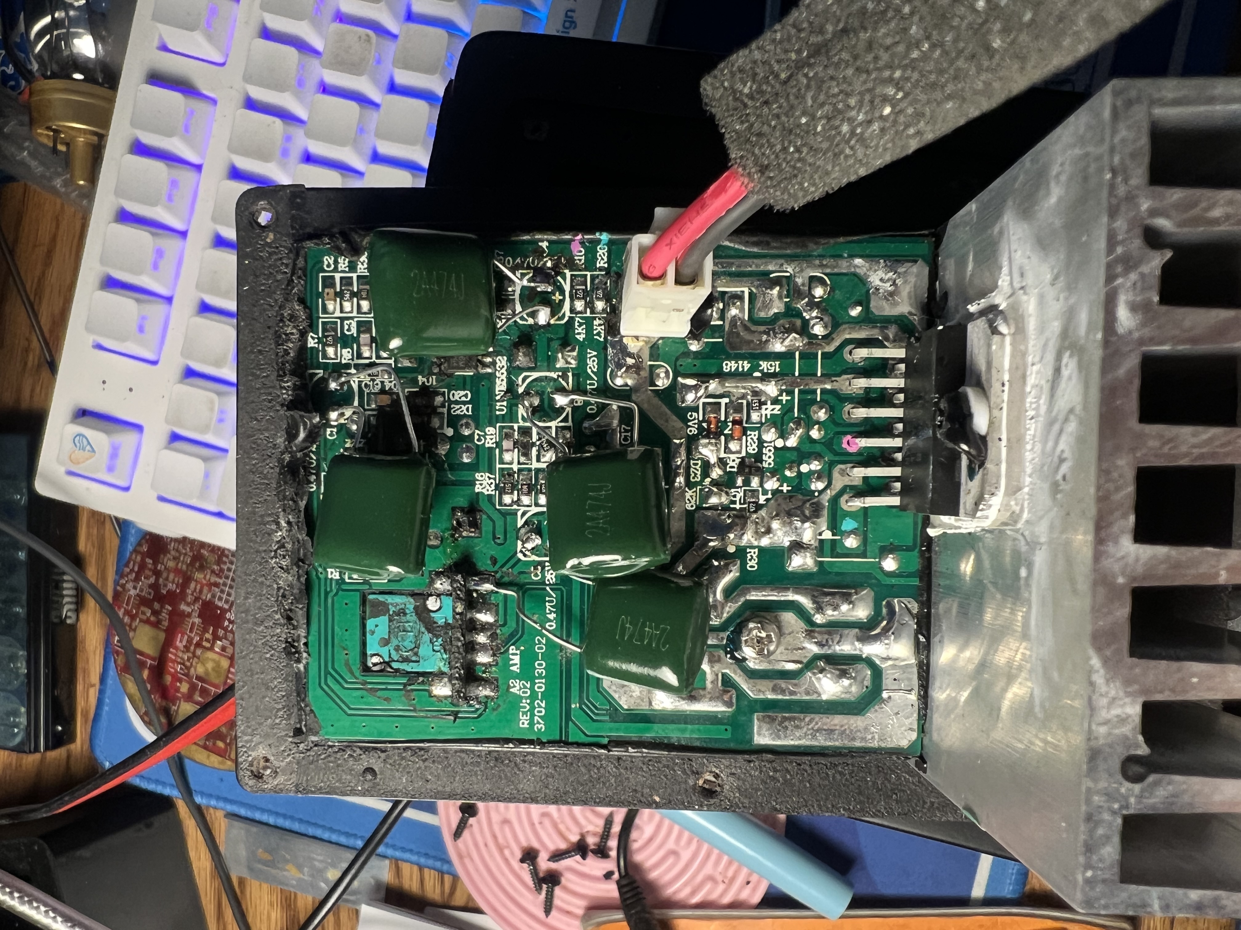Picture showing a circuit board with large green capacitors soldered down