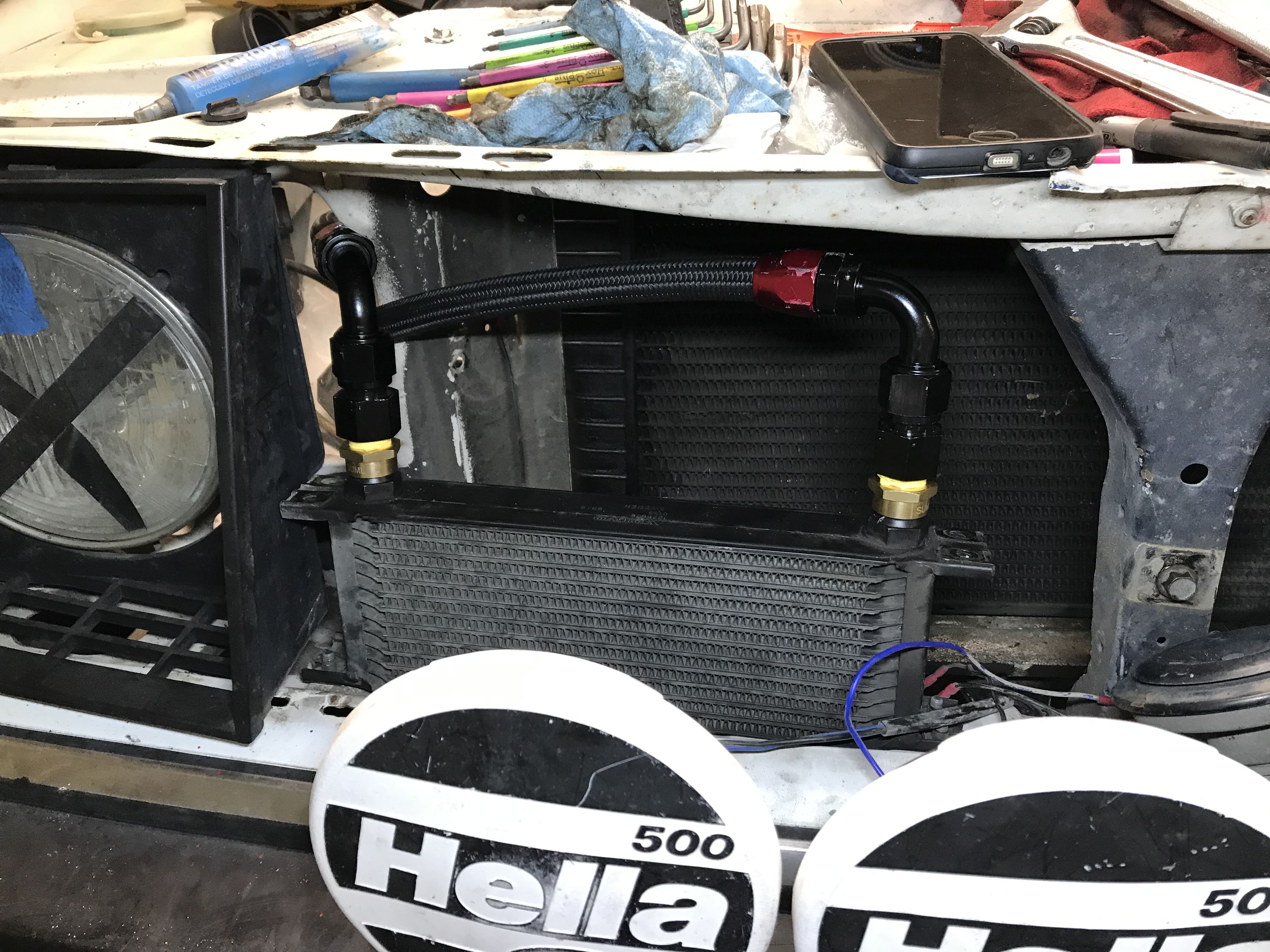 Oil cooler mounted behind a Hella brand headlamp